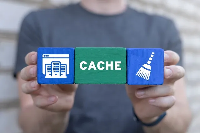Person holding wood blocks with icons and the word "cache"