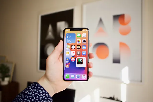 Person holding a smartphone with the full screen visible