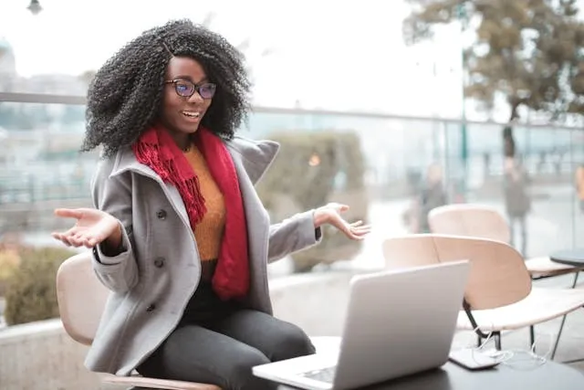 Cheerful person using a laptop outdoors